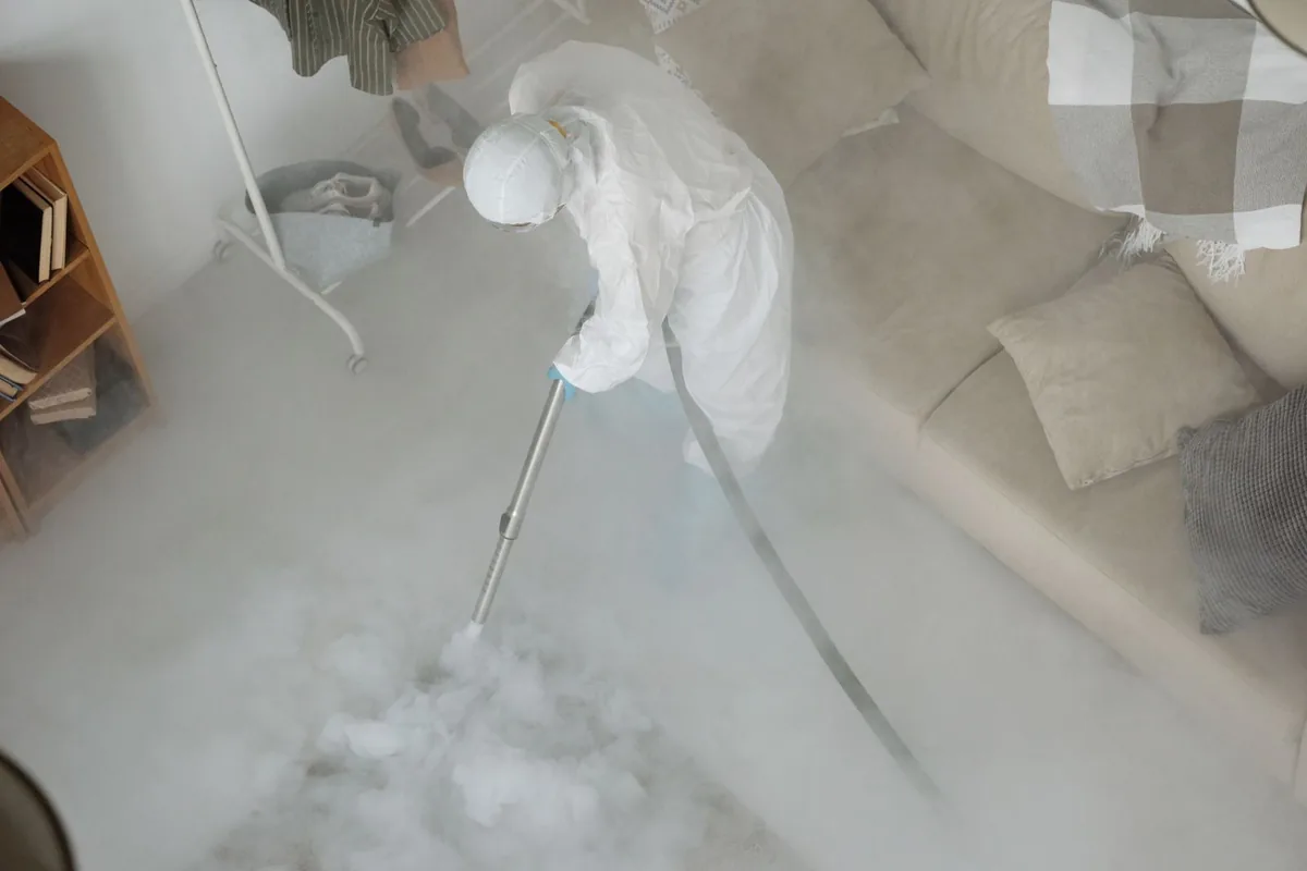 Biohazard cleanup technician in protective equipment, East Cesar Chavez, Austin, TX